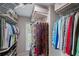 Organized walk-in closet with hanging rods, shelves, and accessories rack for efficient storage solutions at 310 Medridge Dr, Alpharetta, GA 30022