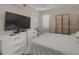 Bright bedroom with a large bed, white dressers, accent screen, and natural light at 314 3Rd Ne St # 4, Atlanta, GA 30308