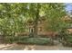 Charming brick townhouse featuring a cozy, tree-lined entrance with wrought iron fence at 314 3Rd Ne St # 4, Atlanta, GA 30308