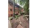 Charming brick exterior of a multi-story condo with landscaped front yard and stepping stone path at 314 3Rd Ne St # 4, Atlanta, GA 30308