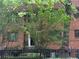 Brick townhouse with black wrought iron fence and lush green landscaping creates a charming curb appeal at 314 3Rd Ne St # 4, Atlanta, GA 30308