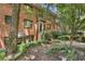 Brick townhome with lush, shady landscaping surrounding the front entrance at 314 3Rd Ne St # 4, Atlanta, GA 30308