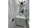 Modern bathroom features white vanity with marble countertop and decorative light fixture at 1340 Stoneleigh Way, Stone Mountain, GA 30088