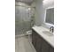 Stylish bathroom features a glass shower door, gray vanity and modern fixtures at 1340 Stoneleigh Way, Stone Mountain, GA 30088