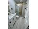 Updated bathroom with new sink, shower with gold accents, and LED vanity mirror at 1340 Stoneleigh Way, Stone Mountain, GA 30088