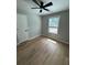 Clean bedroom with new flooring, a ceiling fan, and a large window at 1340 Stoneleigh Way, Stone Mountain, GA 30088