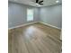 Spacious bedroom featuring new laminate flooring, ceiling fan, and a window at 1340 Stoneleigh Way, Stone Mountain, GA 30088