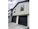 This home showcases its two-car garage and the new white siding accented with black trim at 1340 Stoneleigh Way, Stone Mountain, GA 30088
