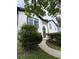 Lovely home exterior with a beautiful wood door and lush landscaping in the front yard at 1340 Stoneleigh Way, Stone Mountain, GA 30088