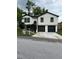 Charming renovated home featuring a new white siding, black trim, and a two-car garage at 1340 Stoneleigh Way, Stone Mountain, GA 30088