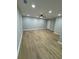 Spacious living room with recessed lights and ceiling fan, showcasing new laminate floors at 1340 Stoneleigh Way, Stone Mountain, GA 30088