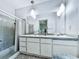 Bathroom featuring a double sink vanity with vintage lighting and a shower/tub combination at 1467 Shiloh Trail East Nw, Kennesaw, GA 30144