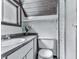 Bathroom features a toilet, sink, shower, and storage shelves at 1467 Shiloh Trail East Nw, Kennesaw, GA 30144