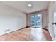 Sunlit bedroom featuring wood floors and glass sliding doors to an outdoor balcony at 1467 Shiloh Trail East Nw, Kennesaw, GA 30144
