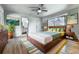 Modern bedroom features hardwood floors, ceiling fan, and ensuite bathroom at 1467 Shiloh Trail East Nw, Kennesaw, GA 30144