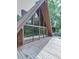 Close-up of a deck with a view of large A-frame windows and surrounding trees at 1467 Shiloh Trail East Nw, Kennesaw, GA 30144