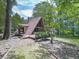 A-frame house with a deck surrounded by a wooded area at 1467 Shiloh Trail East Nw, Kennesaw, GA 30144