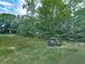 View of a golf course with a golf cart parked on the green, surrounded by mature trees at 1467 Shiloh Trail East Nw, Kennesaw, GA 30144
