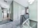 Hallway featuring stone floors, metal railings, and views to other rooms at 1467 Shiloh Trail East Nw, Kennesaw, GA 30144