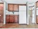 Galley style kitchen with white refrigerator, wood cabinets, and durable flooring at 1467 Shiloh Trail East Nw, Kennesaw, GA 30144