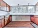 Kitchen featuring wood cabinets and large window with view to outdoors at 1467 Shiloh Trail East Nw, Kennesaw, GA 30144