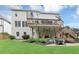 Expansive backyard with a raised deck, lower patio, and lush greenery, perfect for outdoor entertaining at 1487 Monarch Ct, Marietta, GA 30062
