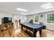 Spacious basement area with hardwood floors, pool table, and ample lighting, perfect for recreation and entertainment at 1487 Monarch Ct, Marietta, GA 30062