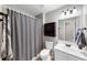 This is a bathroom featuring a shower-tub combo with neutral walls and a white vanity at 1487 Monarch Ct, Marietta, GA 30062