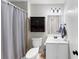 This bathroom features a white vanity, neutral walls, and a shower-tub combo at 1487 Monarch Ct, Marietta, GA 30062