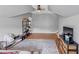 Spacious attic bedroom features wood floors, gray walls, a ceiling fan, and a gray rug at 1487 Monarch Ct, Marietta, GA 30062