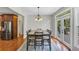 Dining room with a dark wood table set, hardwood floors, and access to the outdoor deck at 1487 Monarch Ct, Marietta, GA 30062