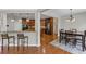Dining area with wood floors, modern lighting, and a view of the kitchen at 1487 Monarch Ct, Marietta, GA 30062