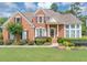 Charming brick home featuring a well-manicured lawn and lush landscaping at 1487 Monarch Ct, Marietta, GA 30062