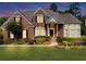 Charming brick home featuring a well-manicured lawn and lush landscaping at 1487 Monarch Ct, Marietta, GA 30062