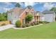 Brick home with well-maintained landscaping and an attached two-car garage at 1487 Monarch Ct, Marietta, GA 30062