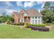 Charming brick home with a well-maintained lawn, mature landscaping, and a welcoming front entrance at 1487 Monarch Ct, Marietta, GA 30062