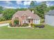 Beautiful brick home with a manicured lawn and landscaping, showcasing its curb appeal at 1487 Monarch Ct, Marietta, GA 30062