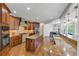 An open concept kitchen features wood cabinets, granite countertops, an island, and stainless steel appliances at 1487 Monarch Ct, Marietta, GA 30062