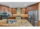 A kitchen features wood cabinets, stainless appliances, a tile backsplash, and a large island with double sinks at 1487 Monarch Ct, Marietta, GA 30062