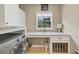 Laundry room with front loading washer and dryer, granite countertop, utility sink, and dog crate at 1487 Monarch Ct, Marietta, GA 30062