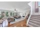 Bright living room with fireplace, windows, hardwood floors, and staircase at 1487 Monarch Ct, Marietta, GA 30062