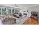 Bright living room with fireplace, large windows, hardwood floors, and a plush sectional sofa at 1487 Monarch Ct, Marietta, GA 30062