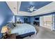 Large main bedroom with a ceiling fan, TV, and easy access to the upper-level stairs at 1487 Monarch Ct, Marietta, GA 30062
