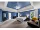 Spacious main bedroom featuring a tray ceiling, fan, and ensuite bathroom entrance at 1487 Monarch Ct, Marietta, GA 30062