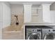 Mudroom features tiled dog wash station, washer, dryer, and built in storage at 1487 Monarch Ct, Marietta, GA 30062