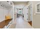 Mudroom with tiled floors, built-in bench with storage, laundry and utility sink at 1487 Monarch Ct, Marietta, GA 30062