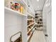 Walk-in pantry features white shelving and tile flooring with plenty of room for storage at 1487 Monarch Ct, Marietta, GA 30062