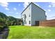 Spacious backyard with a well-maintained lawn, privacy fence, and a view of the home's exterior at 3735 Hazel Ave, Cumming, GA 30040