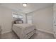 Comfortable bedroom with a cozy bed, carpet flooring, and natural light at 3735 Hazel Ave, Cumming, GA 30040