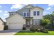 Charming two-story home featuring a two-car garage, stone accents and manicured landscaping at 3735 Hazel Ave, Cumming, GA 30040